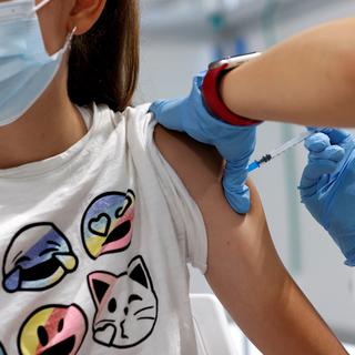 Une adolescente reçoit une injection du vaccin contre le Covid-19. [EPA/Keystone - Chema Moya]