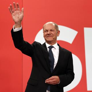 epa09490219 Olaf Scholz, chancellor candidate of the German Social Democrats (SPD), waves to supporters in reaction to initial results at SPD headquarters during the Social Democratic Party (SPD) election event in Berlin, Germany, 26 September 2021. About 60 million Germans were eligible to vote in the elections for a new federal parliament, the 20th Bundestag. EPA/MAJA HITIJ/ POOL [EPA/Keystone - Maja Hittij]