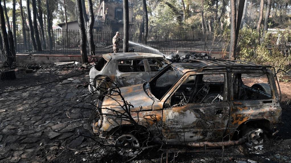 Des dégâts dûs à l'incendie, au nord d'Athènes, le 27 juillet 2021. [AFP - Louisa Gouliamaki]