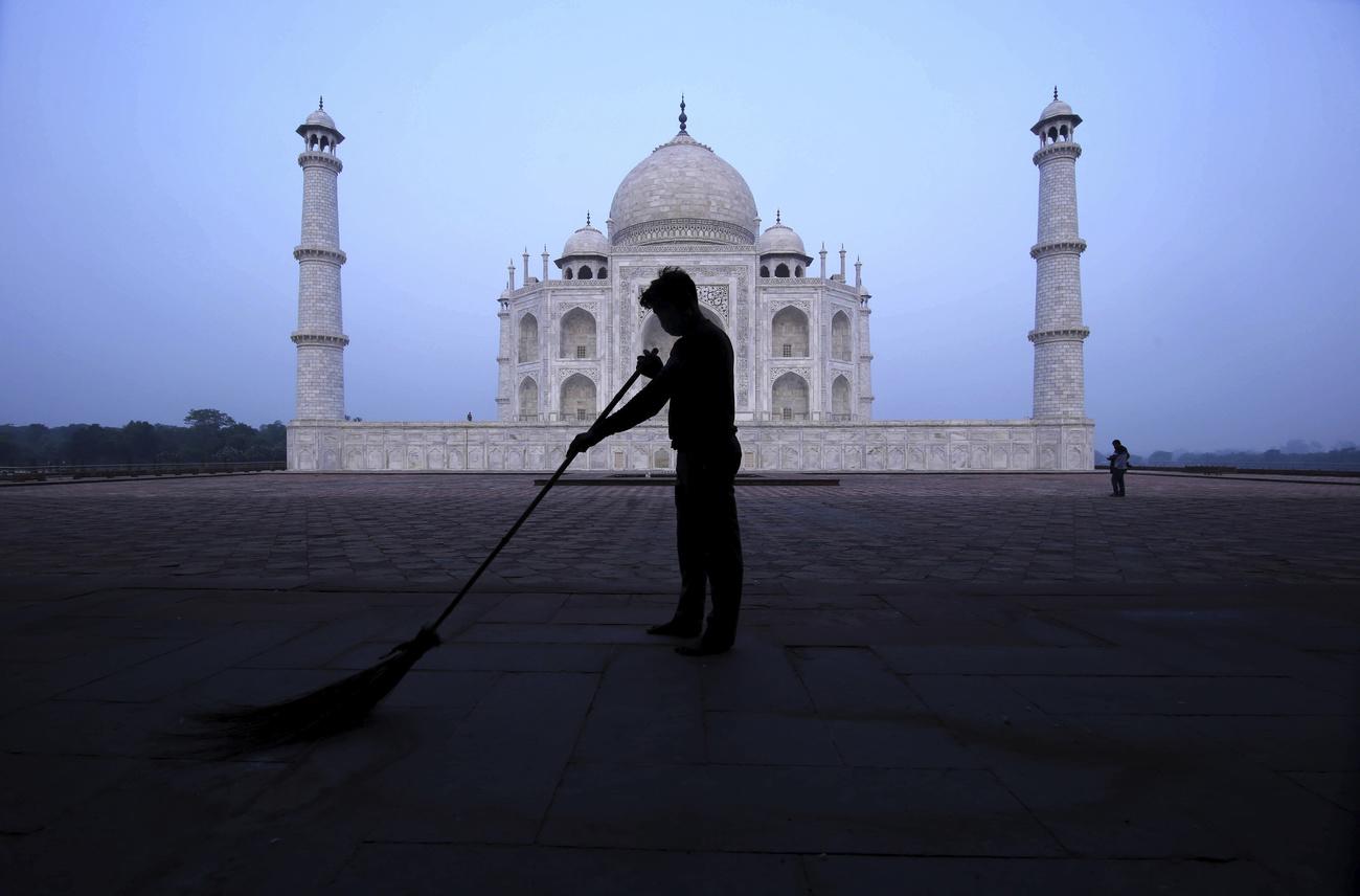Un homme balaie devant le Taj Mahal, tôt le matin. Agra, le 21 septembre 2021. [Keystone/AP photo - Pawan Sharma]