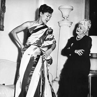 La couturière Nina Ricci, à droite, avec un mannequin à Paris, photo non datée. [Keystone/Photopress-Archiv/Str]