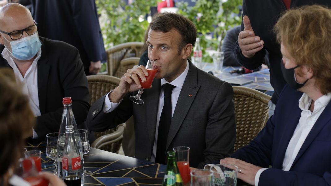 Le président français Emmanuel Macron partage un verre avec des commerçant.e.s à Nevers, le 21 mai 2021. [Keystone/epa - Thibault Camus/Pool Maxppp out]