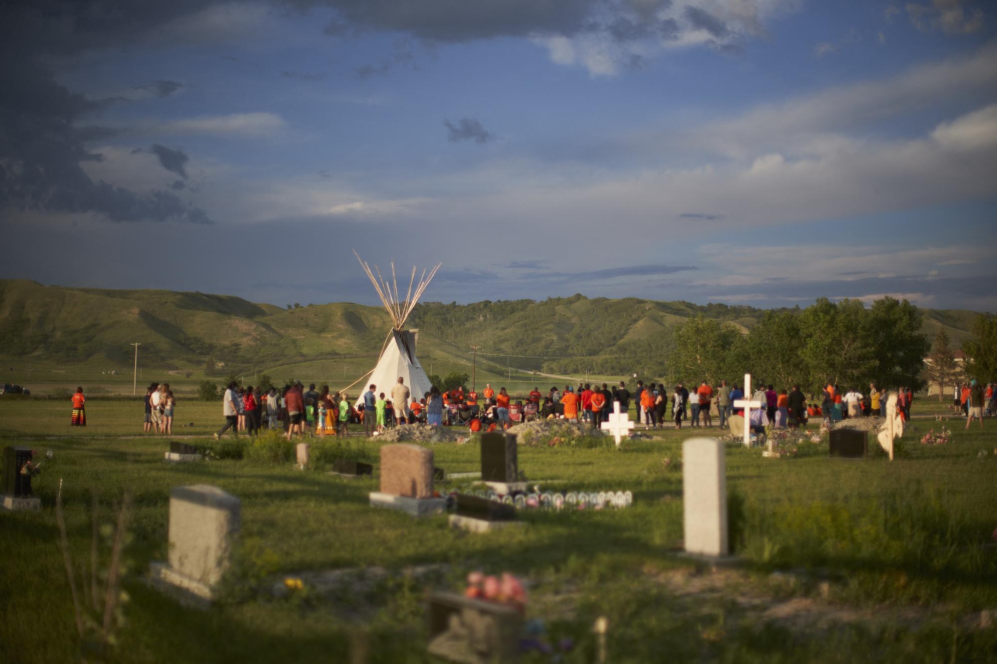 Des membres des communautés autochtones se sont rassemblés samedi pour une veille à proximité de l'emplacement des tombes anonymes. [AFP - Amru Salahuddien]