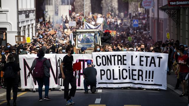 Entre 1000 et 2000 personnes se sont réunies à Lausanne pour manifester contre la loi fédérale contre le terrorisme soumise en votation le 13 juin prochain. [Keystone - Jean-Christophe Bott]