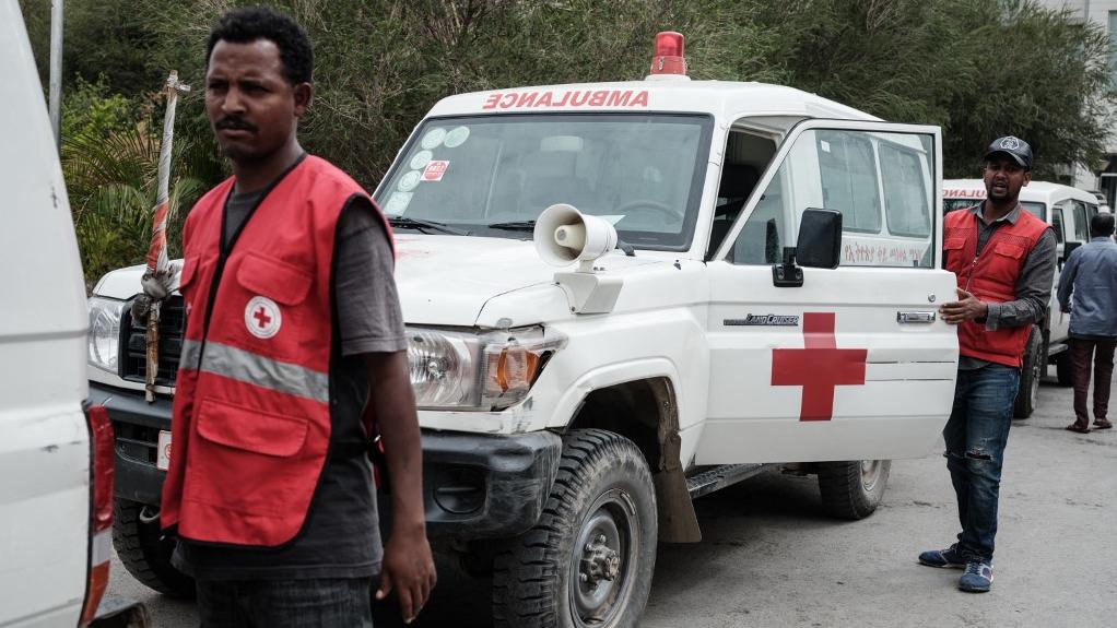 Des ambulances de la Croix Rouge attendent de pouvoir entrer à Togoga, le 23 juin 2021. [AFP - Yasuyoshi Chiba]