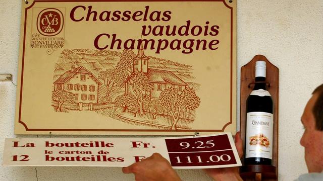 Un caviste prépare les panneaux de vente du Vin vaudois de Champagne en 2002. [Keystone - Fabrice Coffrini]