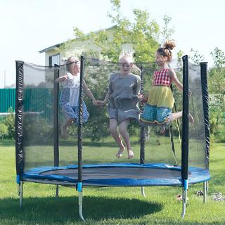 Trois enfants sautent sur un trampoline dans un jardin. [Depositphotos - rogkoff]