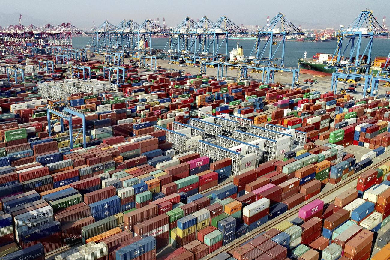 Des conteneurs entreposés dans le port de Qingdao, en Chine. [Keystone - Chinatopix via AP]