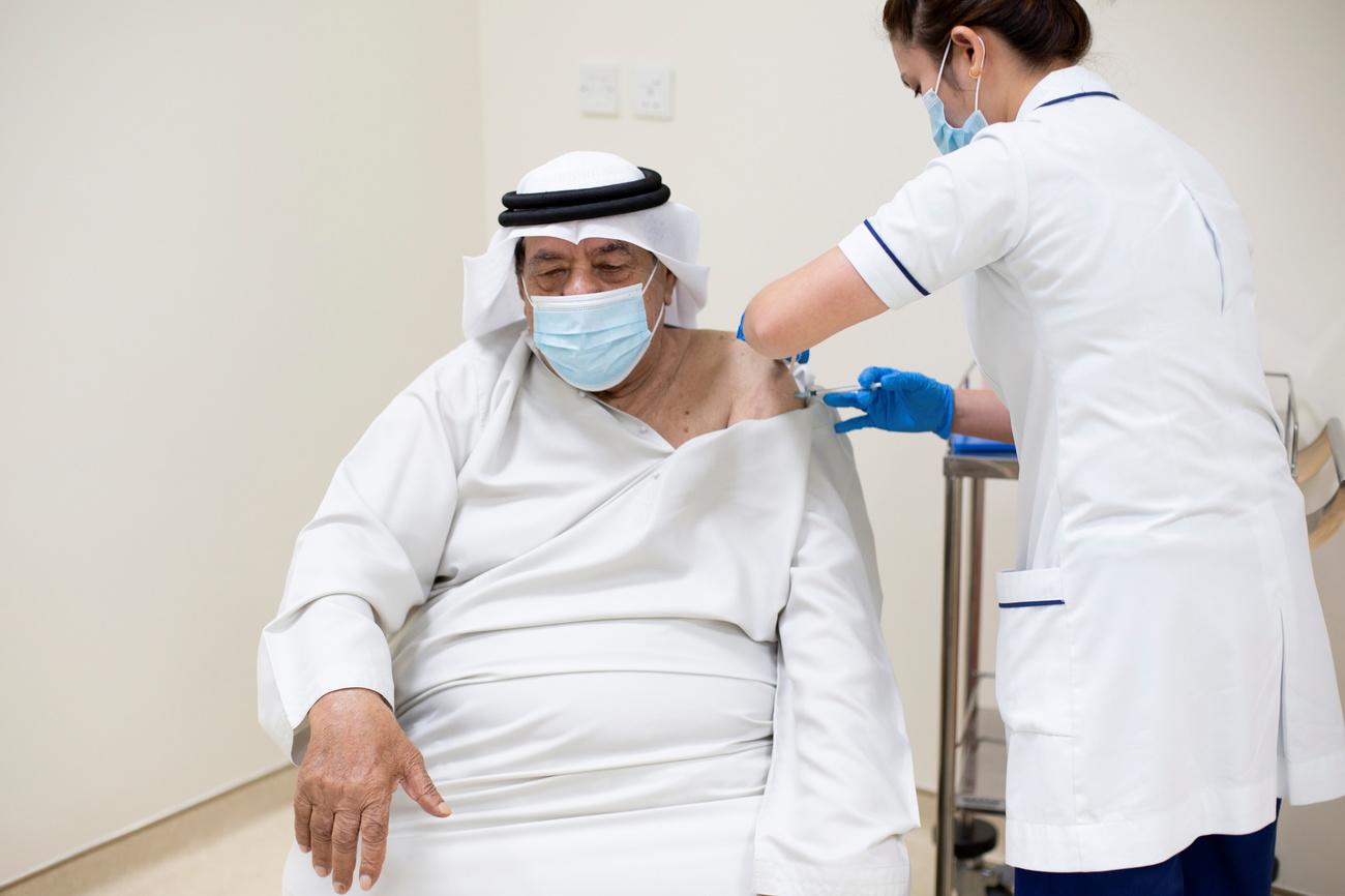 Un homme reçoit une infection du vaccin contre le Covid-19, à Dubai aux Emirats arabes unis. [EPA/Keystone - Autorités de Dubai]