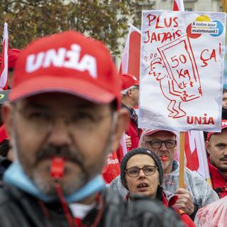 Des personnes participent à une manifestation syndicale pour une revalorisation des salaires et des conditions de travail dans la construction et d'autres domaines, le 30 octobre 2021 à Genève. [Keystone - Martial Trezzini]