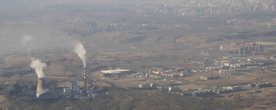 De la fumée et de la vapeur s'échappent des tours de la centrale thermique au charbon d'Urumqi en Chine. [AP Photo/Keystone - Mark Schiefelbein]