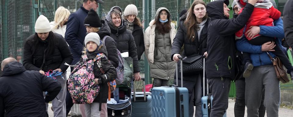 Des milliers d’Ukrainiens ont pris la fuite en direction de la Pologne. [Keystone/AP - Czarek Sokolowski]