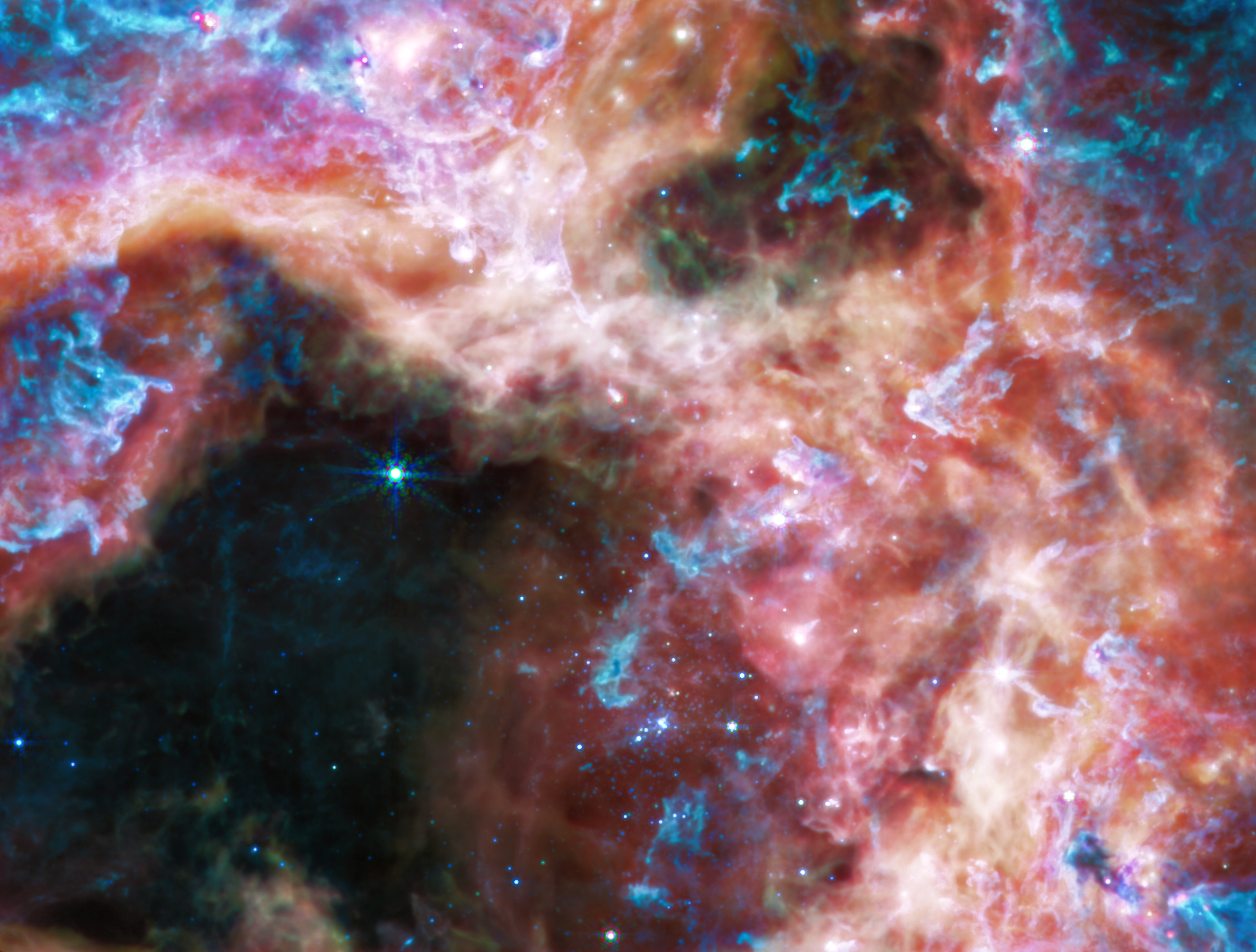 En infrarouge moyen, les jeunes étoiles chaudes de l'amas s'estompent pour laisser la place à du gaz et de la poussière incandescente. [NASA, ESA, CSA, STScI - Webb ERO Production Team]