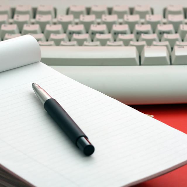 Un bloc-notes, un stylo et un clavier d'ordinateur. [Depositphotos - aremaphoto]