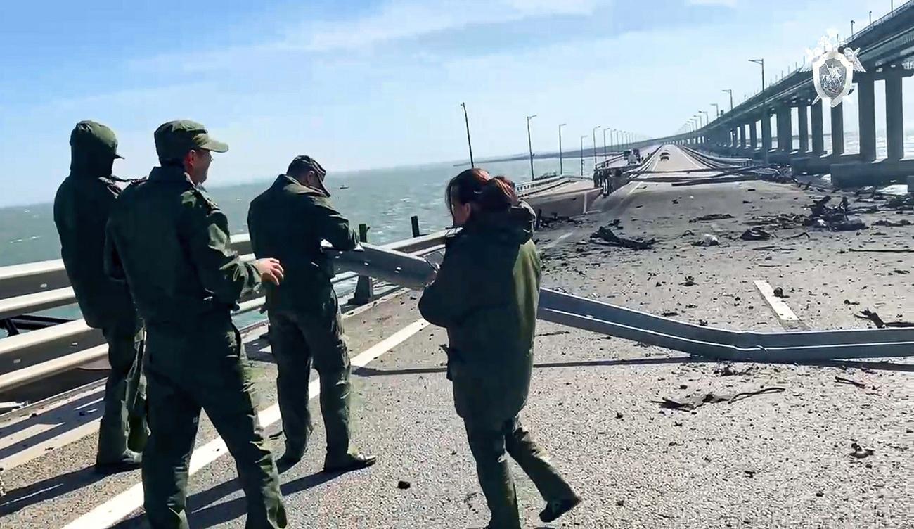 Des enquêteurs du comité d'enquête russe sur l'une des voies du pont de Crimée. [Keystone/Russian Investigative Committee via AP]