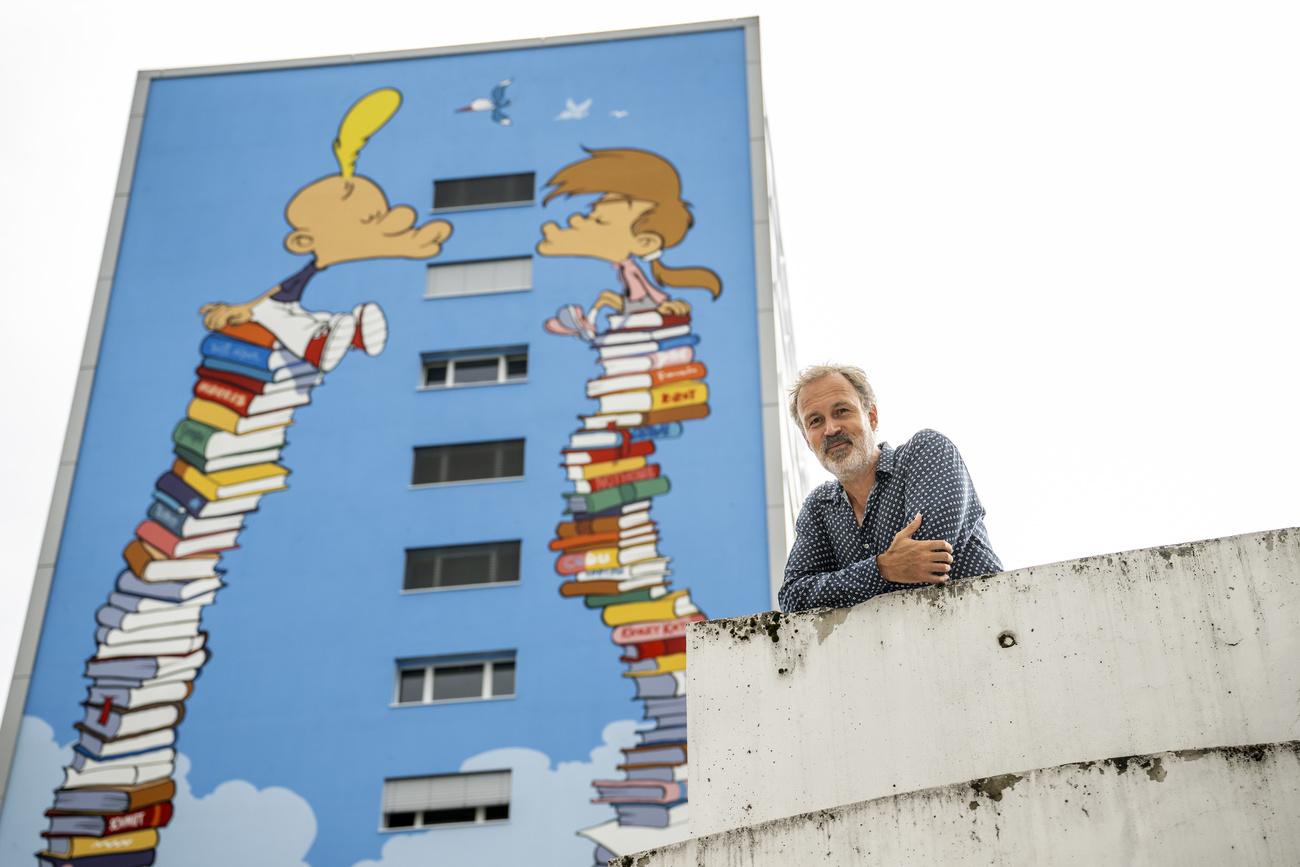 Le dessinateur genevois Philippe Chappuis, mieux connu sous le pseudonyme de Zep, pose devant la fresque peinte sur une façade haute de 50 mètres. [KEYSTONE - Martial Trezzini]