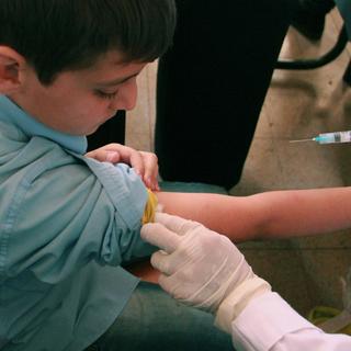 La proportion d'enfants entièrement vaccinés avec le DTP est tombée à 81% en 2021. [Unicef/AP/Keystone - Razan Rashidi]