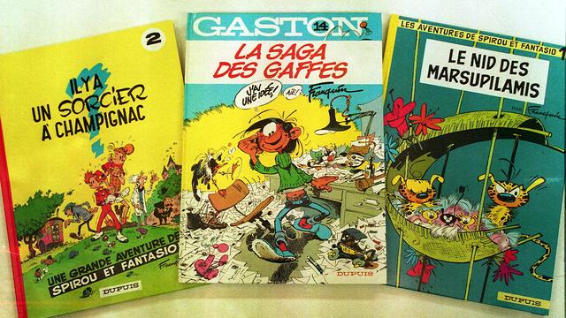 Photo datée du 28 décembre 1993, d'albums de "Gaston Lagaffe" et de "Spirou" du dessinateur belge André Franquin. [AFP - Olivier Matthys]