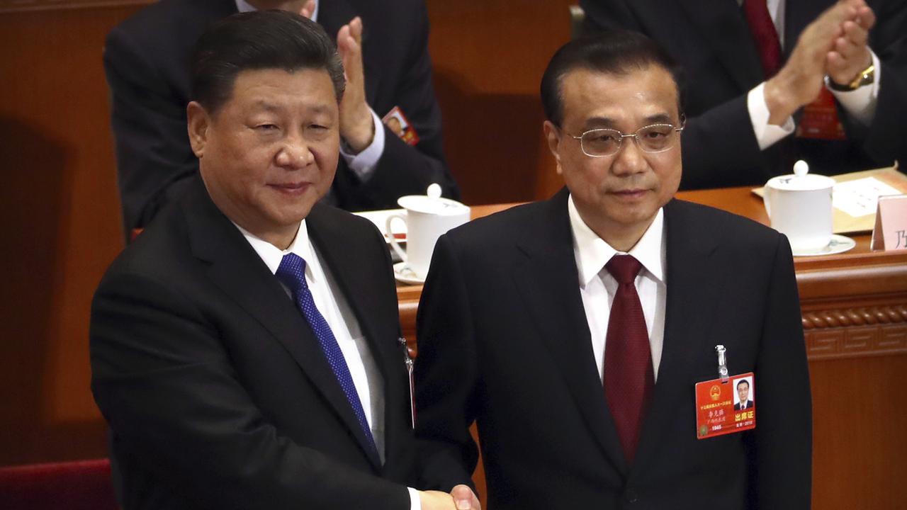 Li Jinping et Li Keqiang lors d'une réunion du Parti communiste chinois. [Keystone - AP Photo/Mark Schiefelbein]