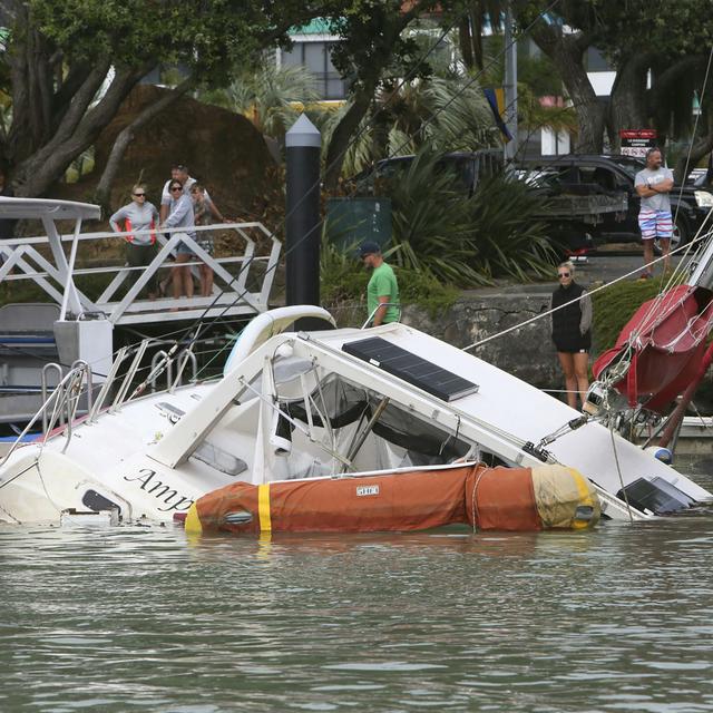 Un bateau sévèrement endommagé à Tutukata, en Nouvelle-Zélande, après le passage des vagues provoquées par l'éruption du volcan Hunga Tonga. [Keystone - Tanya White]