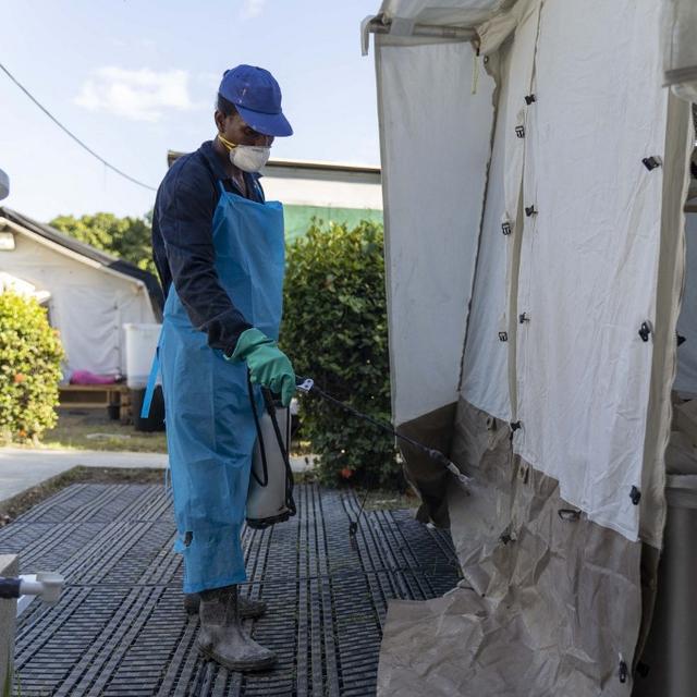 Un homme désinfecte une tente où sont soignés des malades du choléra à Port-au-Prince, en Haïti, le 7 octobre 2022. [AFP - RICHARD PIERRIN]
