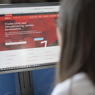 Une femme cherche un emploi pendant son travail sur le portail interne de la société de recrutement Adecco, à Zurich, Suisse, le 3 juin 2019. [KEYSTONE - Gaetan Bally]