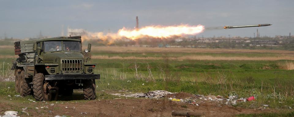 Un lance-roquettes multiple BM-21 Grad fait feu près de l'usine Azovstal à Marioupol. [Reuters - Alexander Ermochenko]