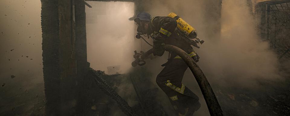 Un pompier ukrainien à Kiev. [Keystone - AP Photo/Vadim Ghirda]