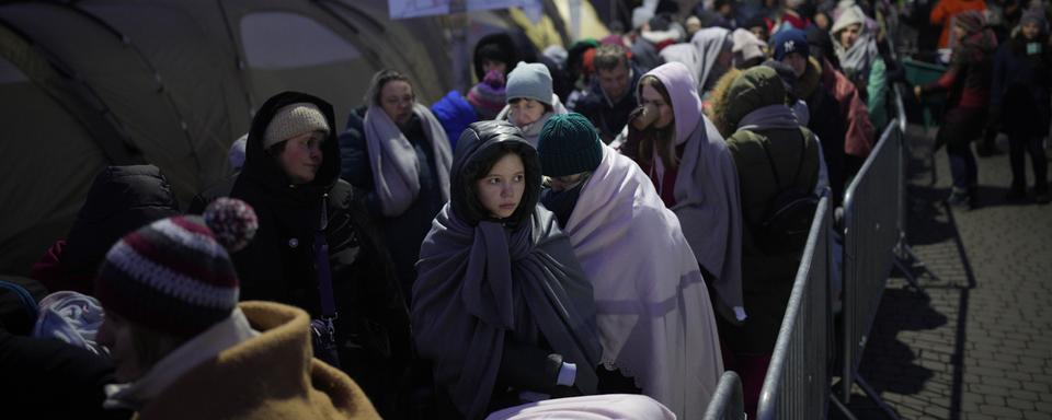 Des réfugiés ukrainiens en Pologne le 10 mars 2022. [AP Photo/Keystone - Daniel Cole]