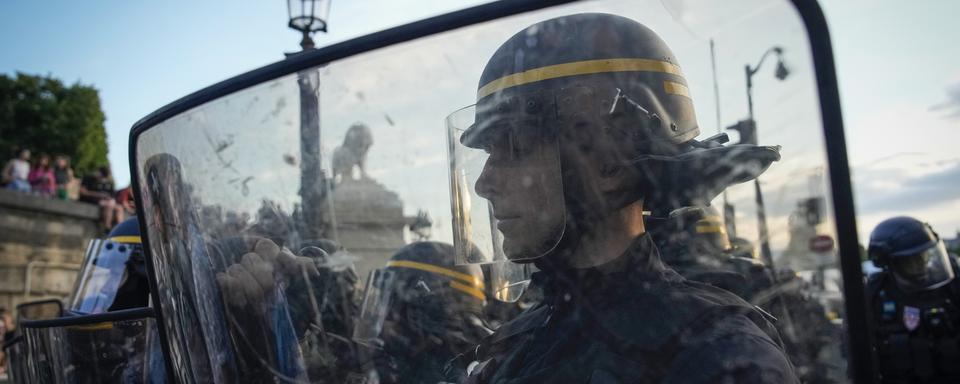 Des policiers pendant les manifestations liées à la mort de Nahel. [Keystone - AP Photo/Lewis Joly]