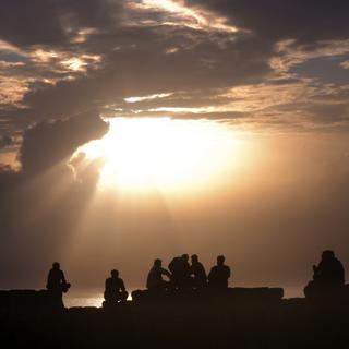 Des personnes regardant le coucher de soleil à Goa, en Inde. [AP Photo/ Keystone - Manish Swarup]