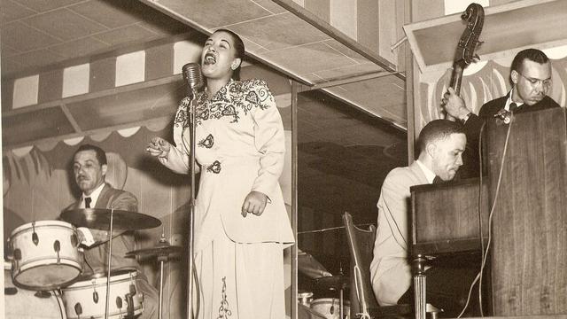 De gauche à droite sur la photo: probablement Al Dunn (batterie), Billie Holiday (chant), Bobby Tucker (piano), inconnu (contrebasse) au Club Bali, Washington, en septembre 1946. [wikimedia - Ralph F. Seghers c/o Ken Seghers]