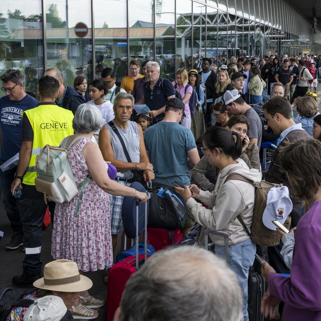 Des passagers arrivent avec leurs bagages pendant que les employés de Genève Aéroport (AIG) sont en grève, le 30 juin 2023. [Keystone]