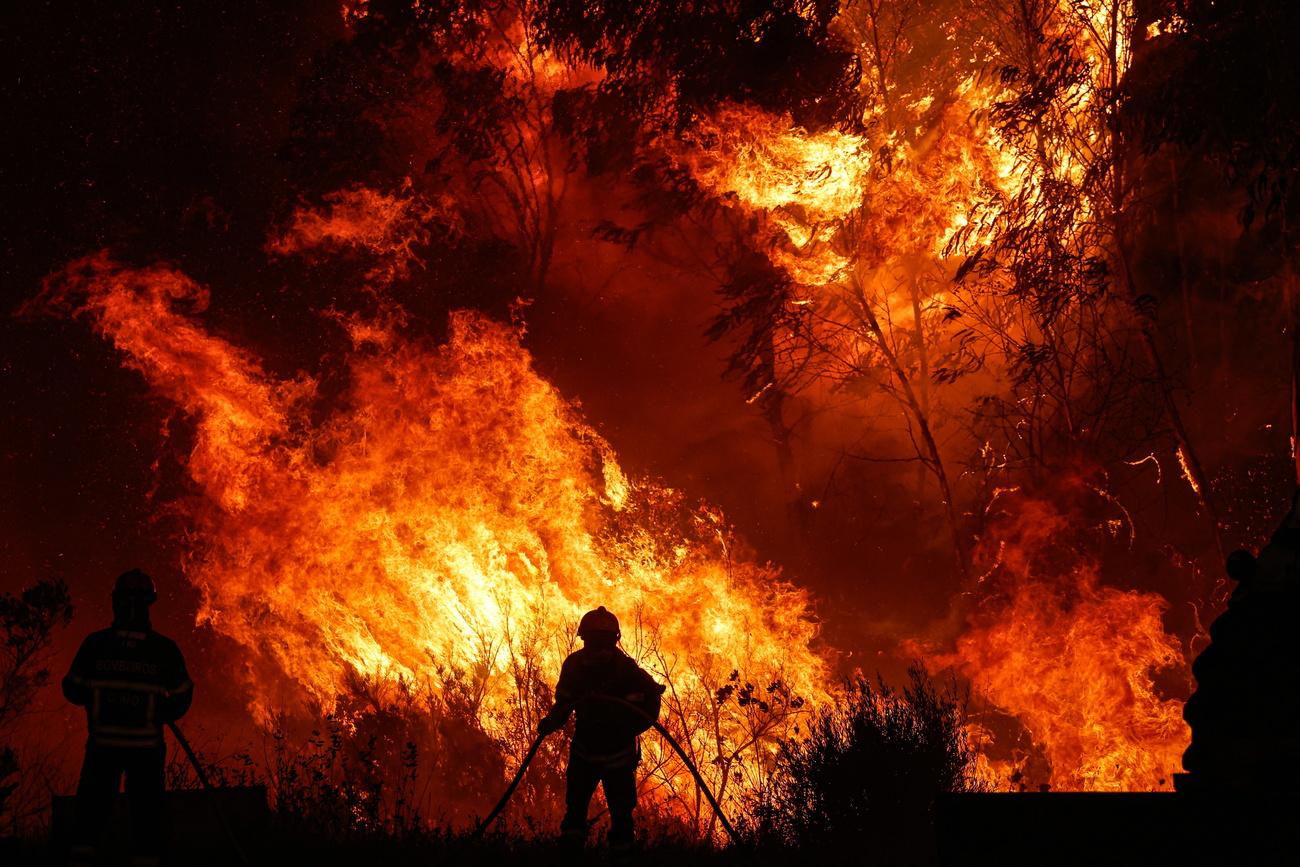 Des pompiers luttent pour éteindre les flammes dans la municipalité d'Odemira. [Keystone - Luis Forra]