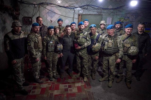 Volodymyr Zelensky pose avec des soldats ukrainiens sur la ligne de front dans l'est du pays. [Handout via Reuters - UKRAINIAN PRESIDENTIAL PRESS SER]