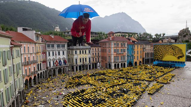 Un employé du musée miniature en plein air de Melide (TI) constate les dégâts dus à la grêle sur la maquette de la Piazza Grande de Locarno le 31 mai 2023. [KEYSTONE/Ti-Press - Davide Agosta]