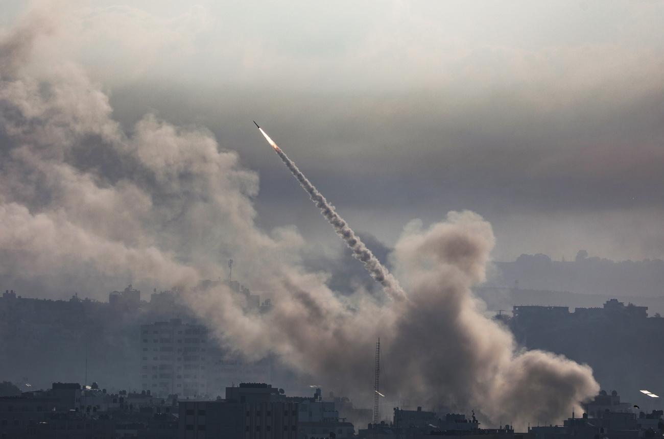 Une roquette est lancée de la bande côtière de Gaza vers Israël par des militants de la milice Ezz Al-Din Al Qassam, l'aile militaire du mouvement Hamas, dans la ville de Gaza, le 7 octobre 2023. [Keystone - EPA/MOHAMMED SABER]