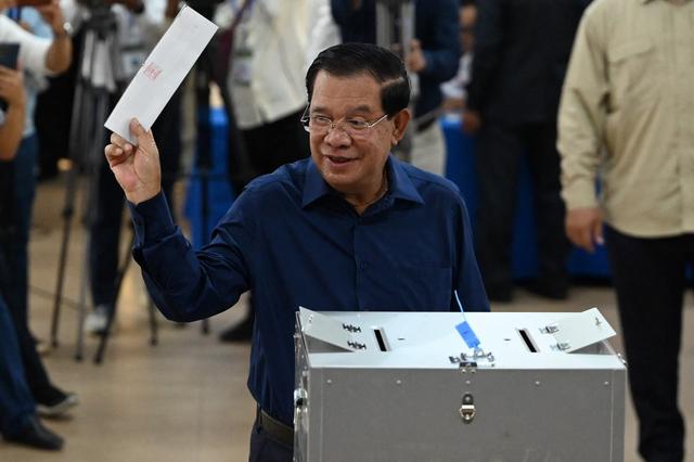 L'actuel Premier ministre Hun Sen lorsqu'il a glissé son bulletin de vote dans l'urne. [afp - TANG CHHIN SOTHY]