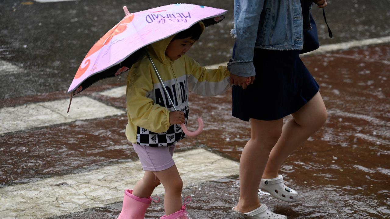 Pékin affronte les pluies torrentielles du typhon Doksuri. [AFP - PEDRO PARDO]