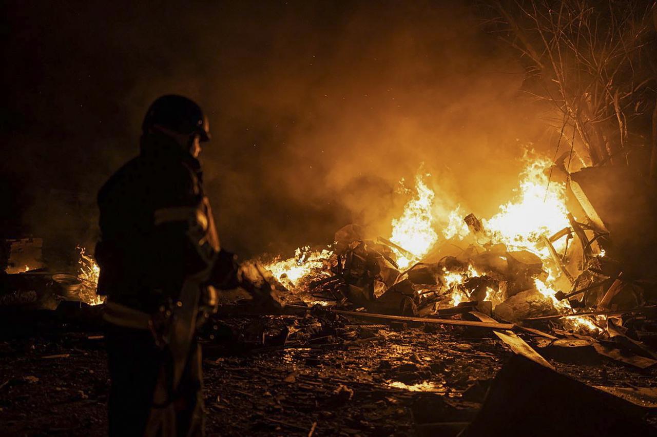 Sur cette photo fournie par le Ministère des situations d'urgence ukrainien, des pompiers éteignent le feu causé par des fragments d'une roquette russe après qu'elle a été abattue par le système de défense aérienne lors de l'attaque nocturne de roquettes russes à Kiev, le 16 mai 2023. [KEYSTONE - STATE EMERGENCY SERVICE OF UKRAINE HANDOUT]