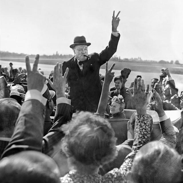 L'ancien Premier ministre britannique Winston Churchill salue la foule lors d'une visite à Genève en 1946. [Keystone - Photopress-archiv/Str]