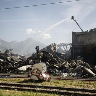 L'incendie, qui a duré toute la nuit, a complètement ravagé la halle industrielle à Vétroz. [Keystone - Louis Dasselborne]