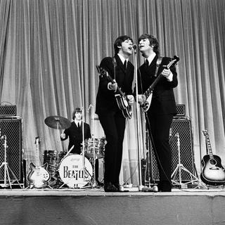 Les Beatles en concert en 1965 à Paris. [AFP]