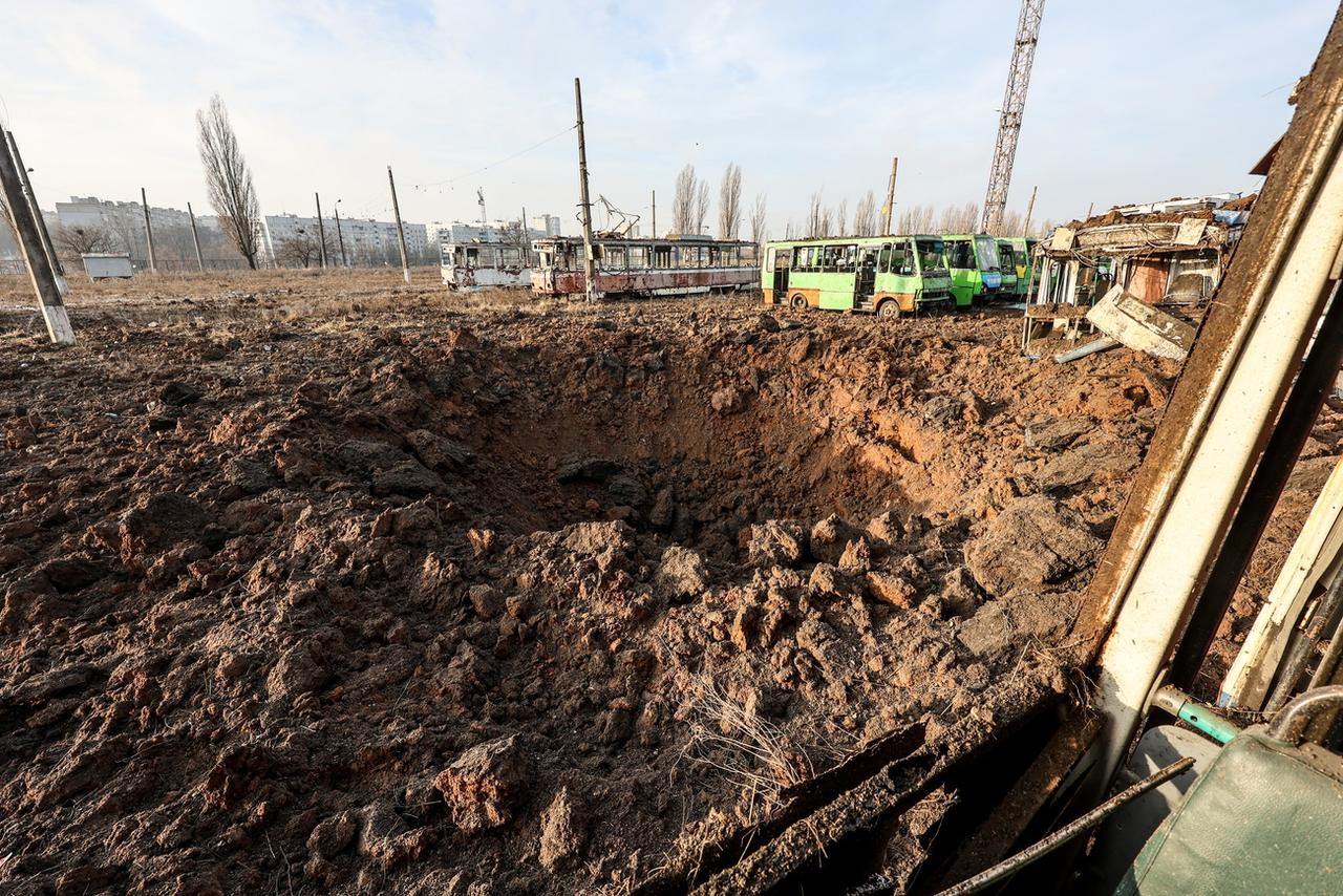 Un cratère après une explosion dans la région de Kharkiv. [Keystone - EPA/Sergey Kozlov]