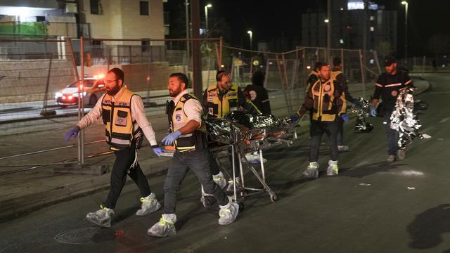 Les secours évacuent un corps après la fusillade meurtrière à Jérusalem. [Keystone - AP Photo/Mahmoud Illean]