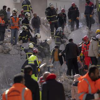 Des sauveteurs recherchent des victimes du tremblement de terre en Turquie et en Syrie. [Keystone - AP Photo/Petros Giannakouris]