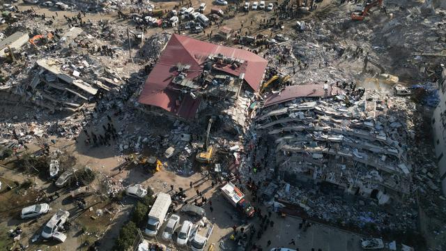 Les secours s'activent le 9 février 2023 parmi les décombres de bâtiments effondrés à la suite du séisme du 6 février à Kahramanmaras, dans le sud-est de la Turquie. [Keystone - EPA/ABIR SULTAN]