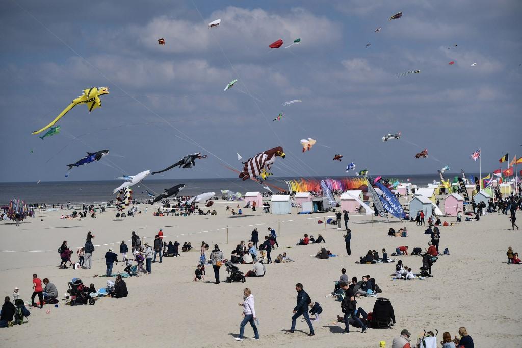 Des amateurs de plage regardent des cerfs-volants géants pendant le Festival international de cerfs-volants de Berck-sur-Mer à Berck, dans le nord de la France, le 19 avril 2023. [AFP - Firas Abdullah / Anadolu Agency]