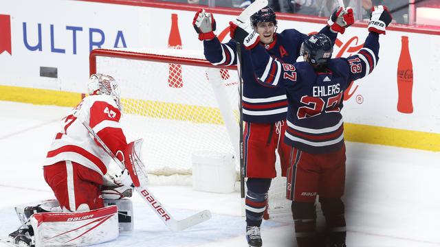 Les joueurs de Winnipeg Mark Scheifele et Nikolaj Ehlers célèbrent leur réussite devant James Reimer. [The Canadian Press via AP - John Woods]