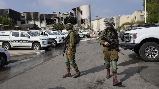 Des soldats israéliens marchent près du poste de police qui a été envahi par des militants du Hamas samedi, à Sderot, Israël, dimanche 8 octobre 2023. [Keystone - AP Photo/Ohad Zwigenberg]